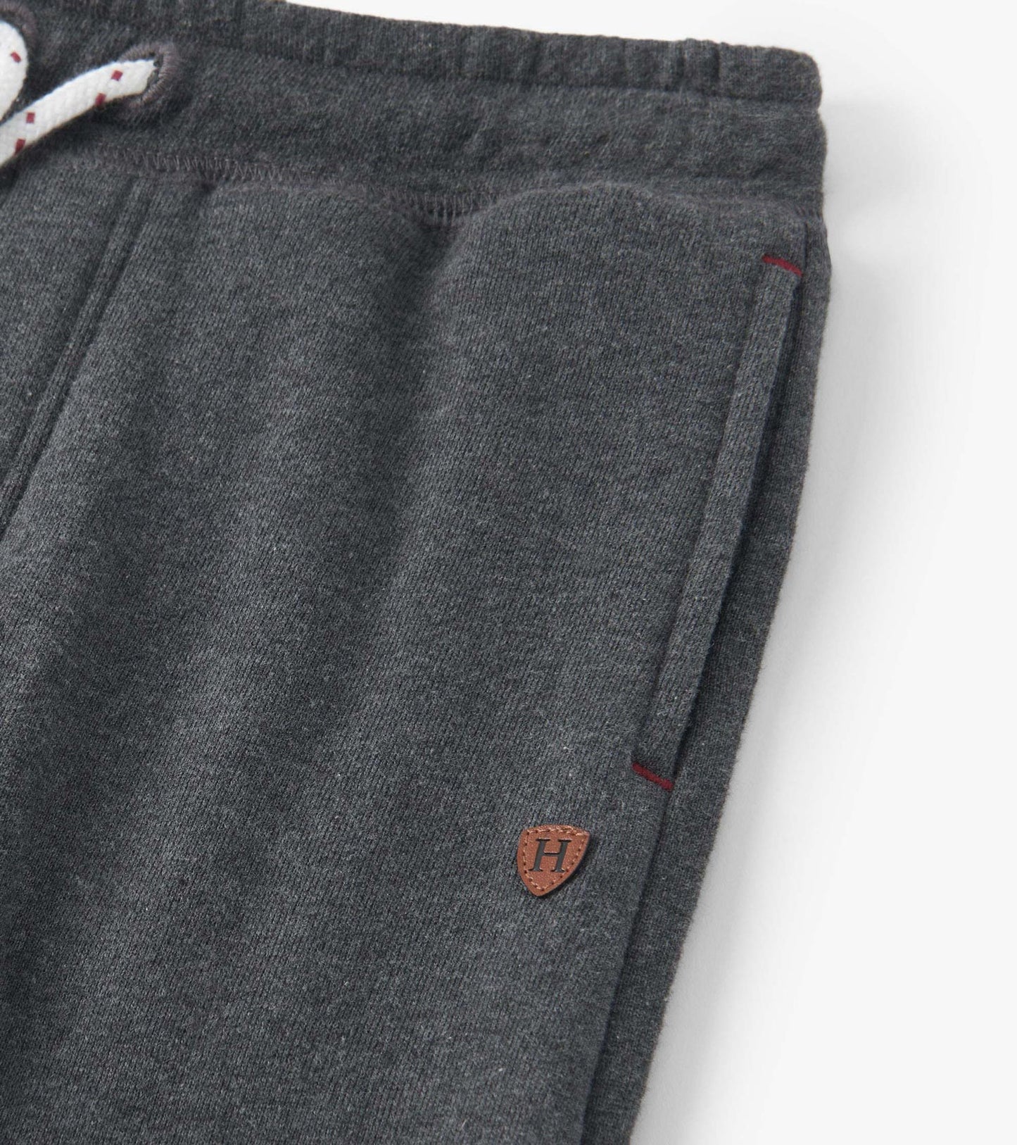 Charcoal melange joggers with a drawstring waist and side pockets, featuring a small logo patch.