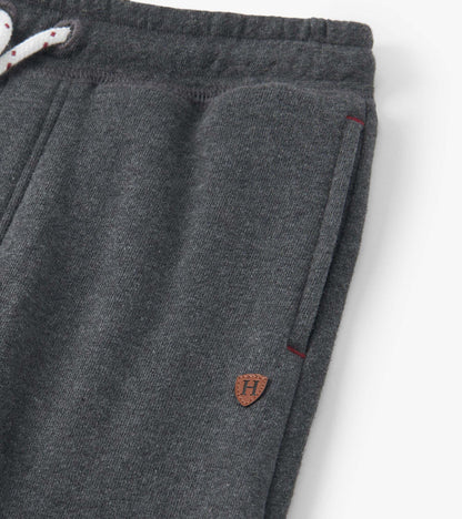 Charcoal melange joggers with a drawstring waist and side pockets, featuring a small logo patch.