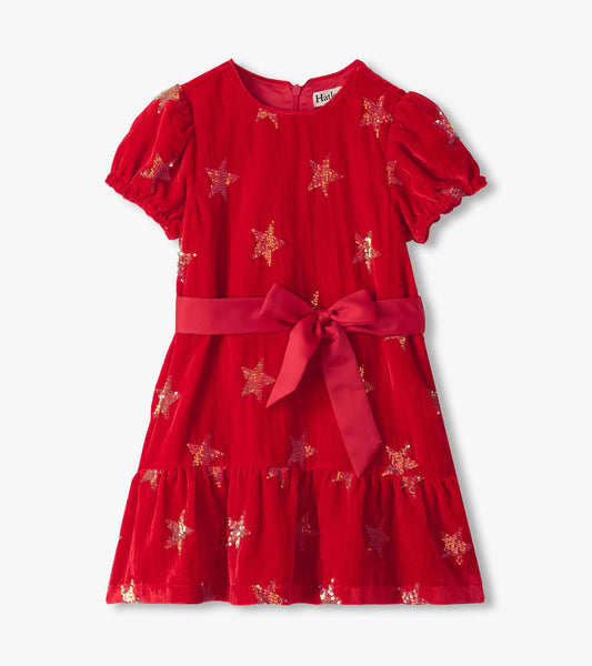 Front view of red dress with puff sleeves, sequin stars, waist tie bow, and tiered skirt