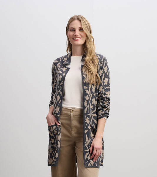 Long-sleeve sweater blazer in navy with floral vine pattern, open front, and side pockets, styled over a white top.