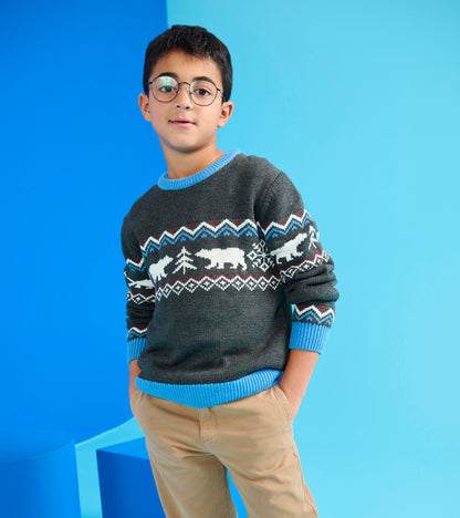Gray crew neck sweater featuring a winter-themed pattern with polar bears and trees, paired with beige pants.