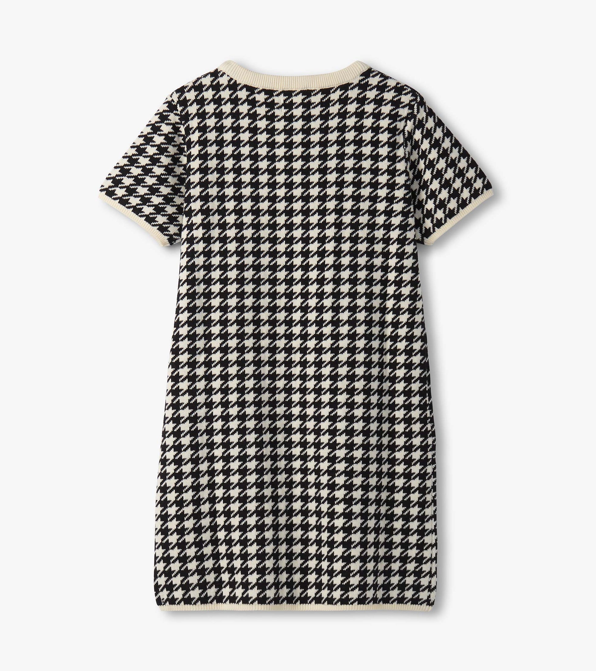 Black and white houndstooth sweater dress with short sleeves and a ribbed neckline, featuring faux fur pockets.