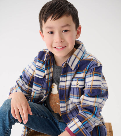 Plaid fleece button-up shirt in blue, white, and brown, featuring two chest pockets, worn over a gray shirt.