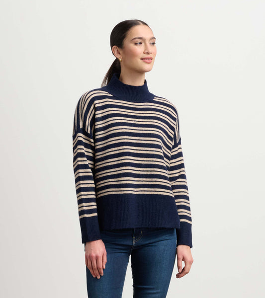 Navy and camel striped mock neck sweater with a relaxed fit and ribbed hem, worn with blue jeans.