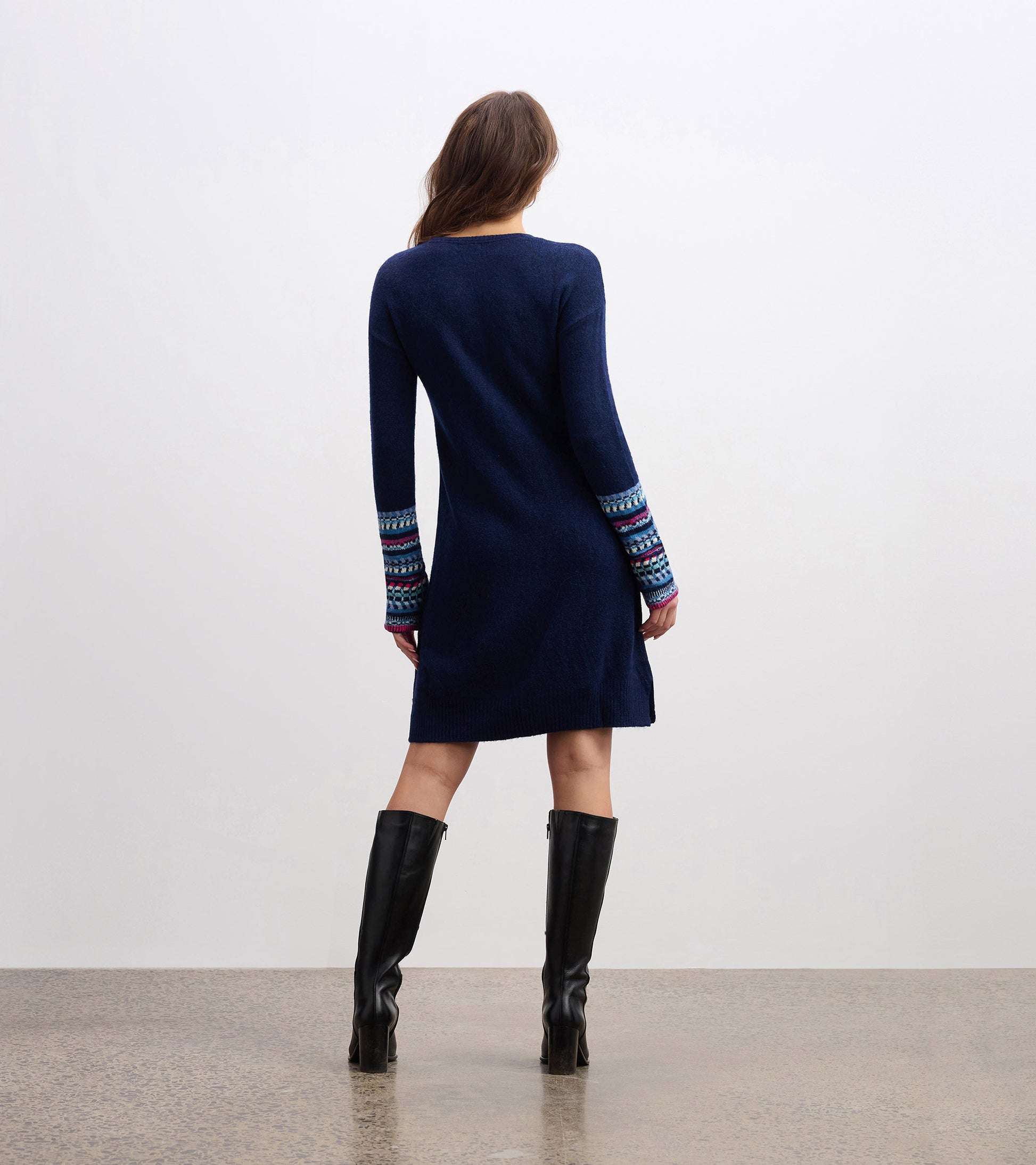 Navy sweater dress with colorful patterned sleeves, featuring a relaxed fit and knee-length design.