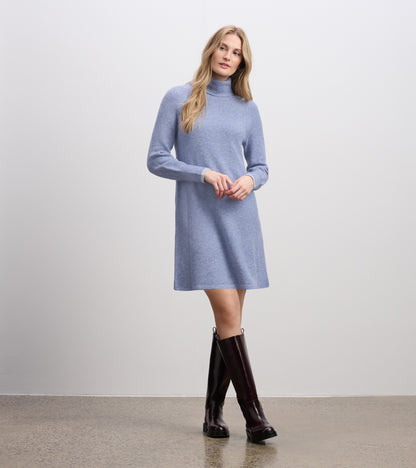 Light denim sweater dress with a mock neck and long sleeves, featuring a relaxed fit and knee-length hem.
