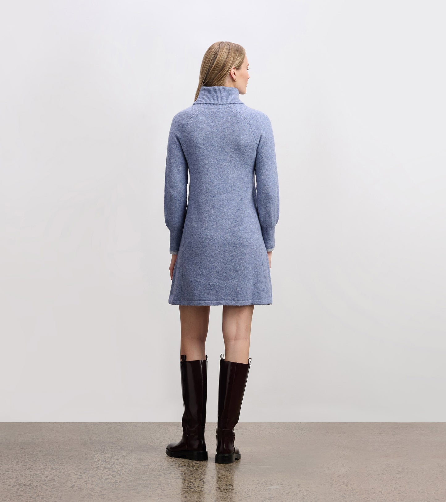 Light denim sweater dress with a high collar and long sleeves, featuring a relaxed fit and above-knee length.