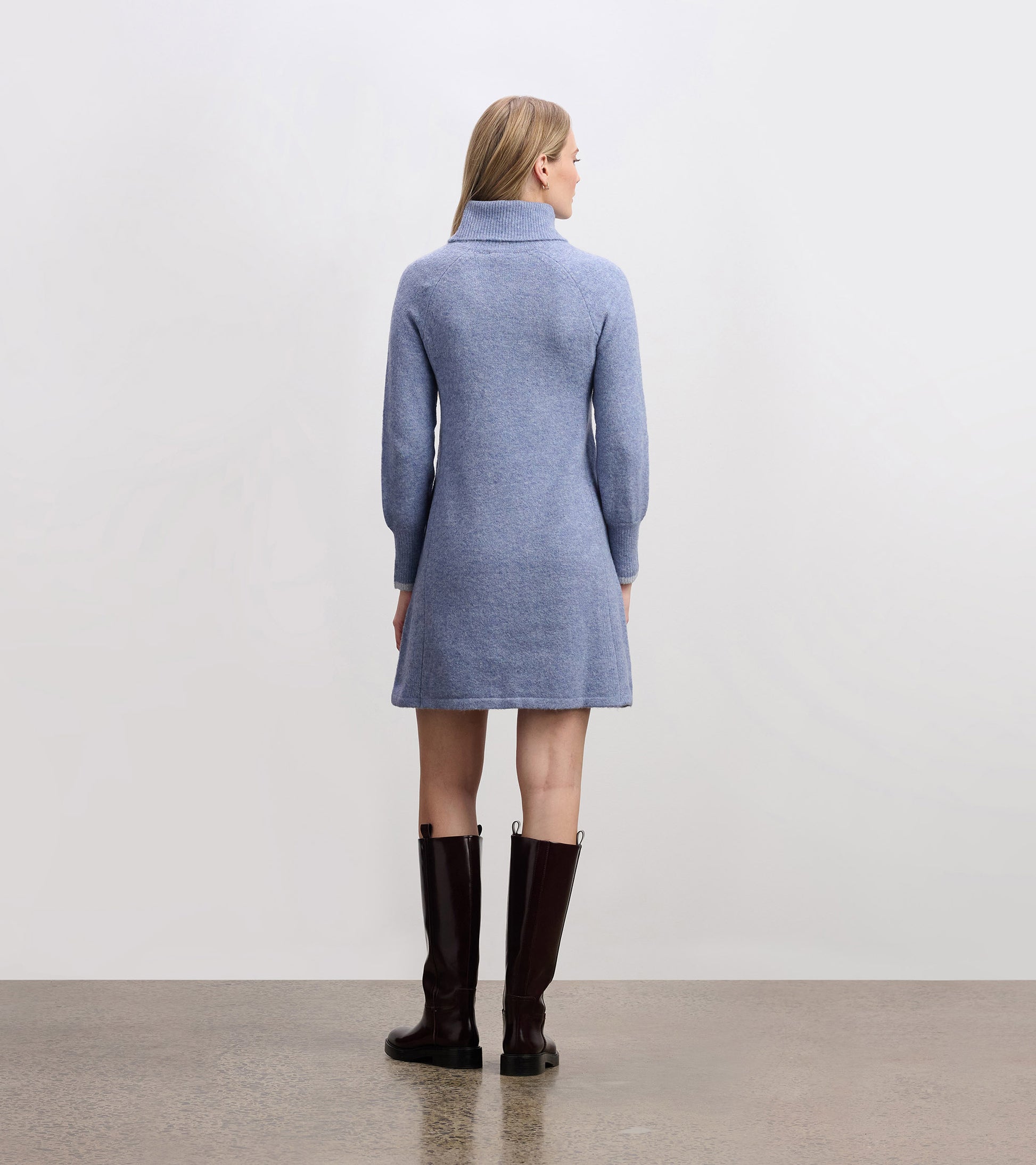 Light denim sweater dress with a high collar and long sleeves, featuring a relaxed fit and above-knee length.