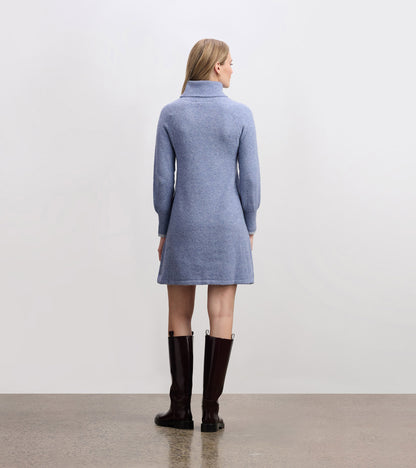 Light denim sweater dress with a high collar and long sleeves, featuring a relaxed fit and above-knee length.