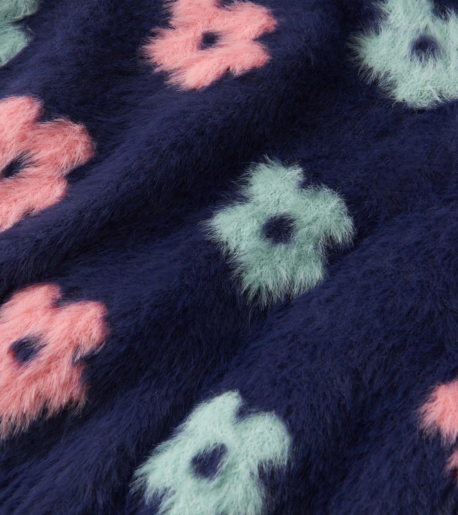 Navy cardigan featuring soft, fluffy fabric with pink and mint green flower patterns.