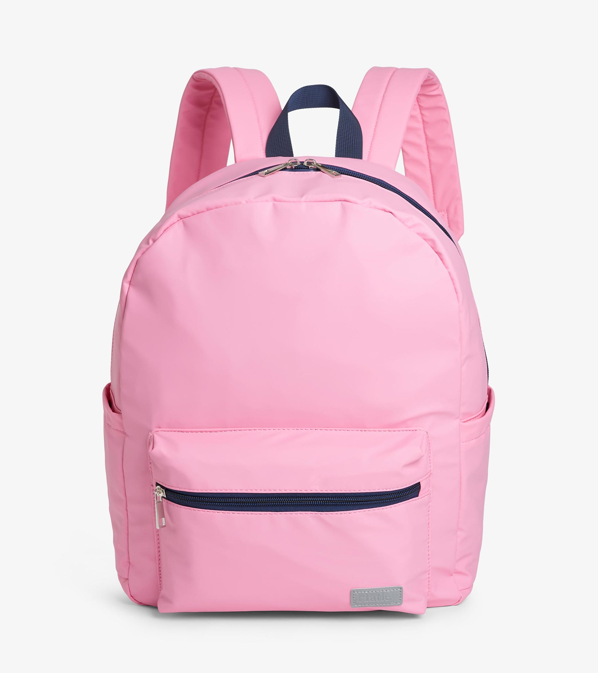 Pink backpack with front zip pocket, side pockets, padded straps, and navy top handle