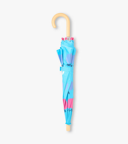 Closed blue umbrella with apple print, pink tips, and curved beige handle