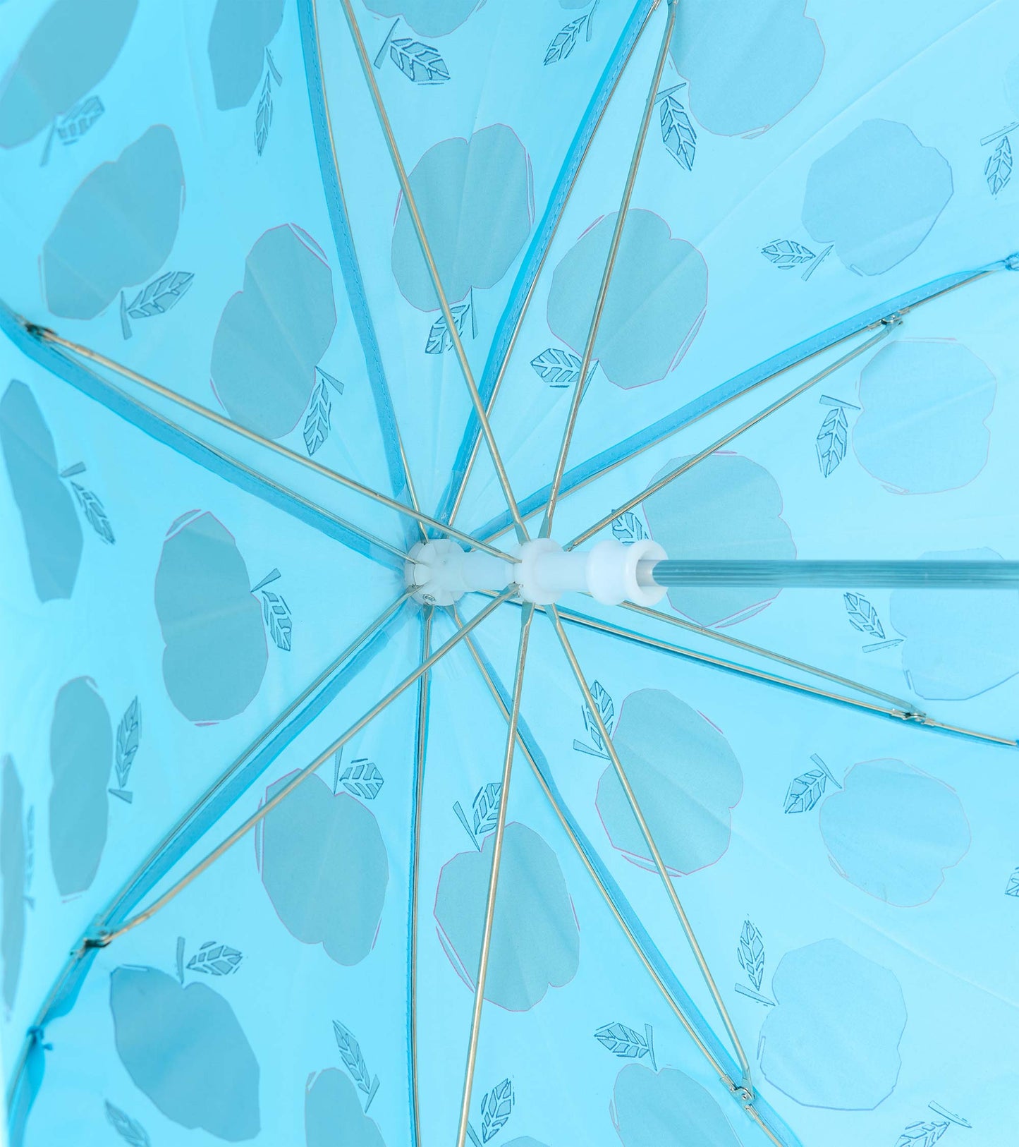 Underside view of blue umbrella showing metal ribs and apple print through the canopy