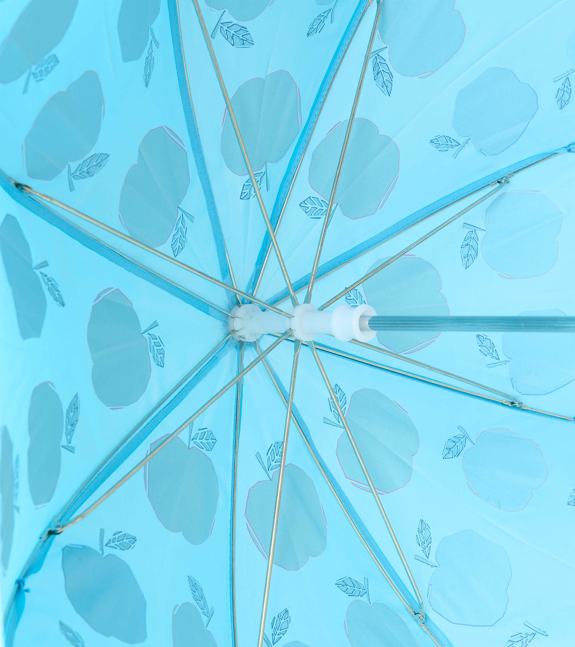 Underside view of blue umbrella showing metal ribs and apple print through the canopy