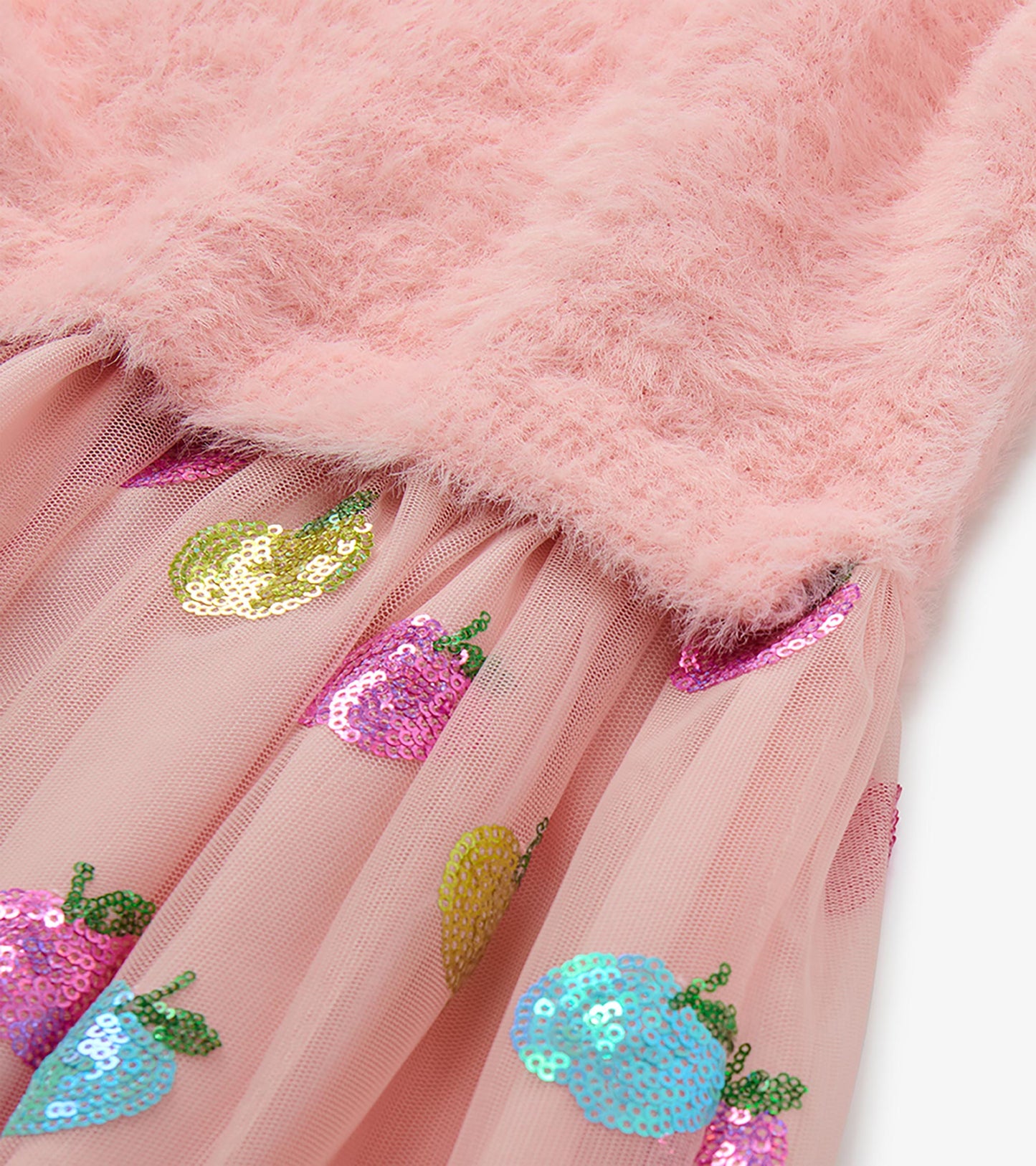 Close-up of pink fuzzy knit bodice and tulle skirt with multicolored sequin apple motifs