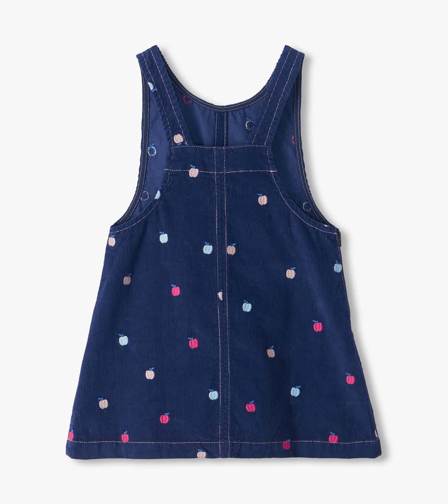 Back of navy pinafore dress with embroidered pink, blue, and beige apples and racerback straps