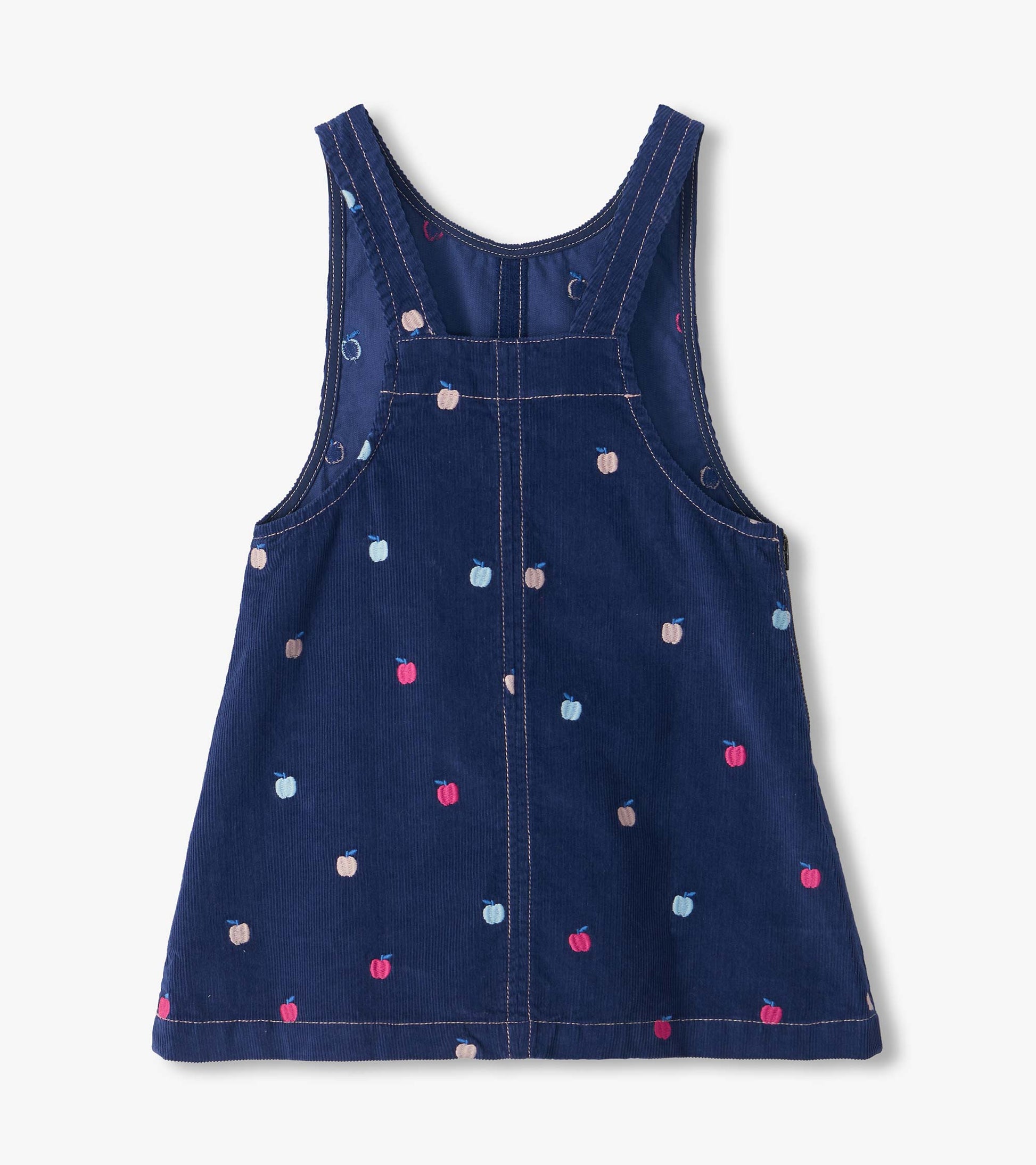Back view of navy apple embroidered pinafore dress with wide shoulder straps