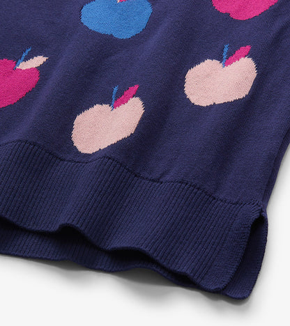 Close-up of navy sweater hem with pink, blue, and pale pink apple pattern and ribbed trim
