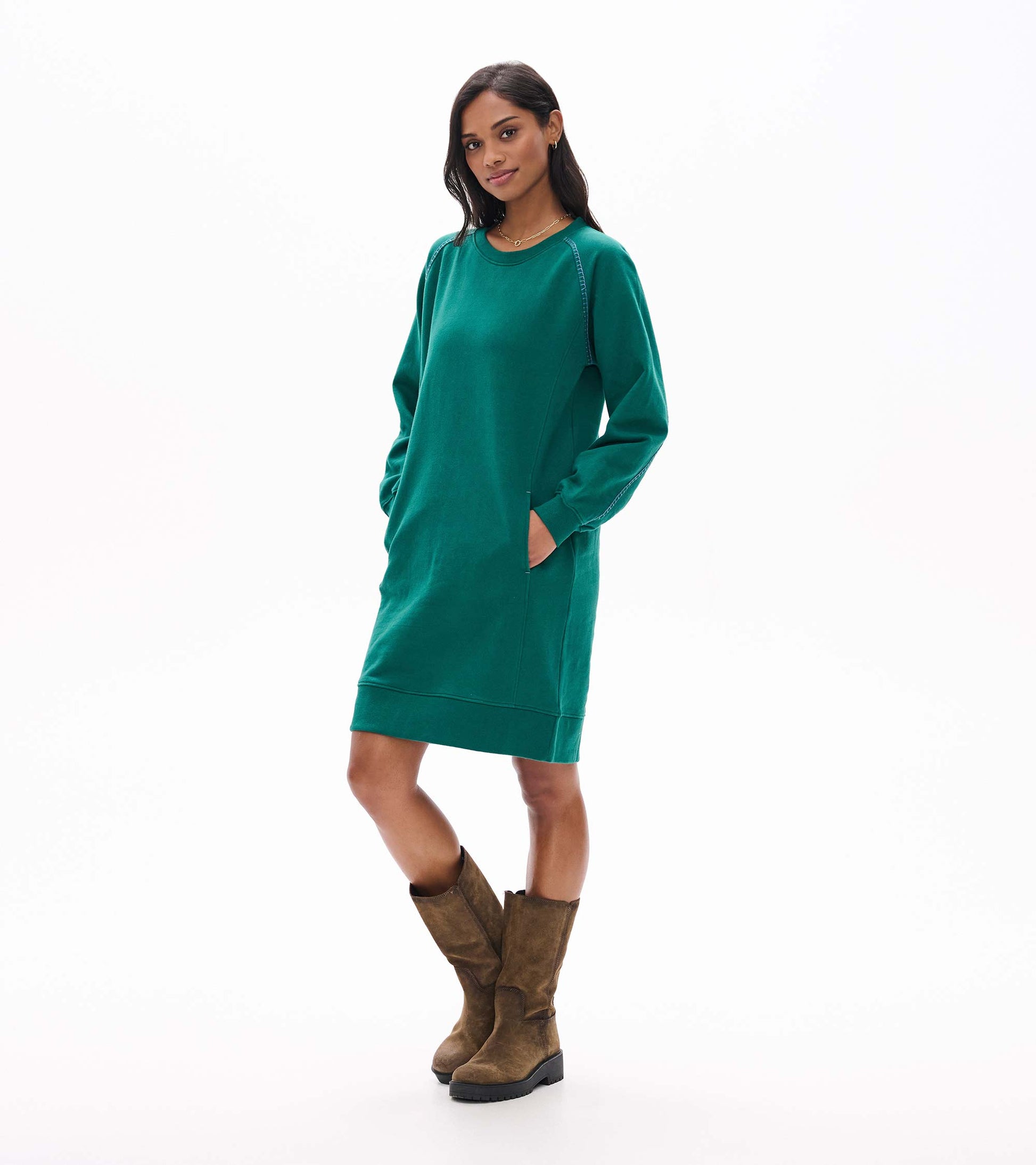 Aventurine green sweatshirt dress with side pockets and contrast seams, angled front view