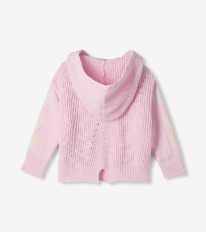 Back view of girls pink hooded pullover sweater with cream heart details on the sleeves and side-slit hem