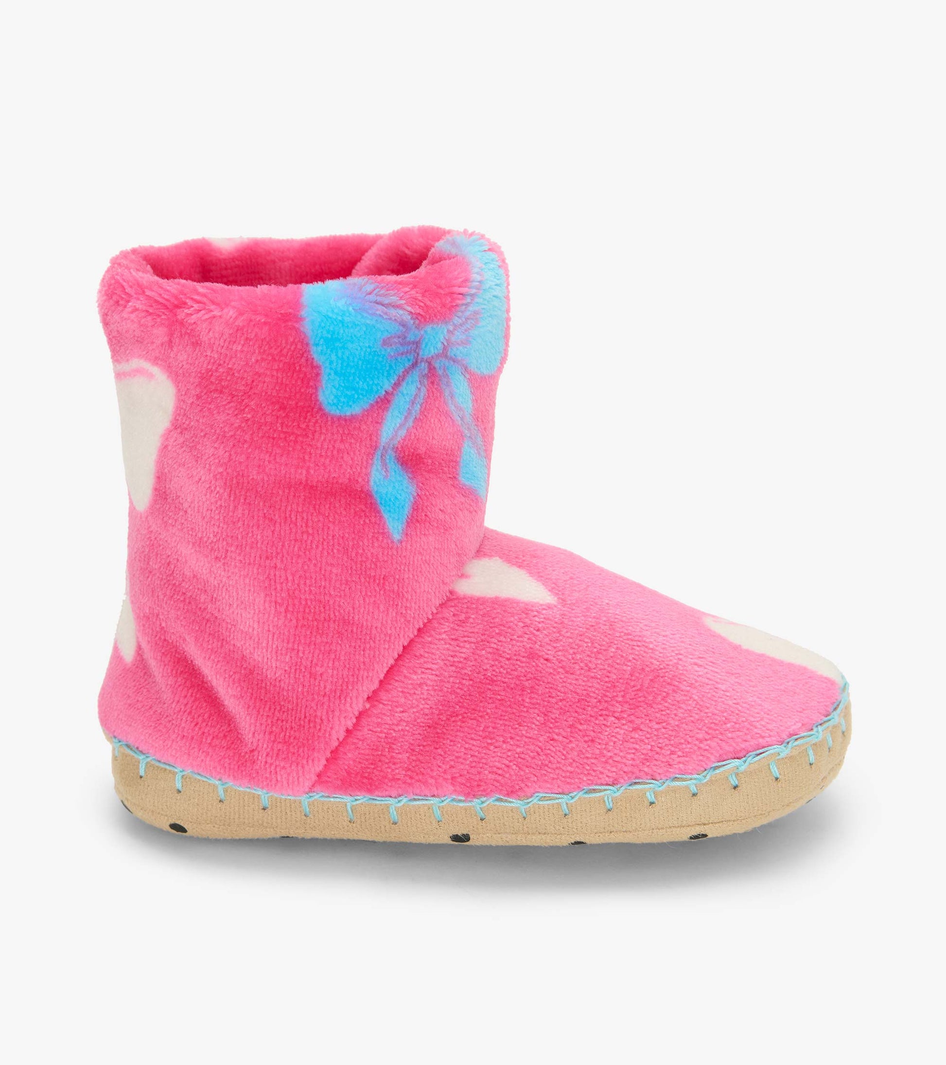 Side view of a pink slipper boot with blue bow print, white spots, and a tan sole
