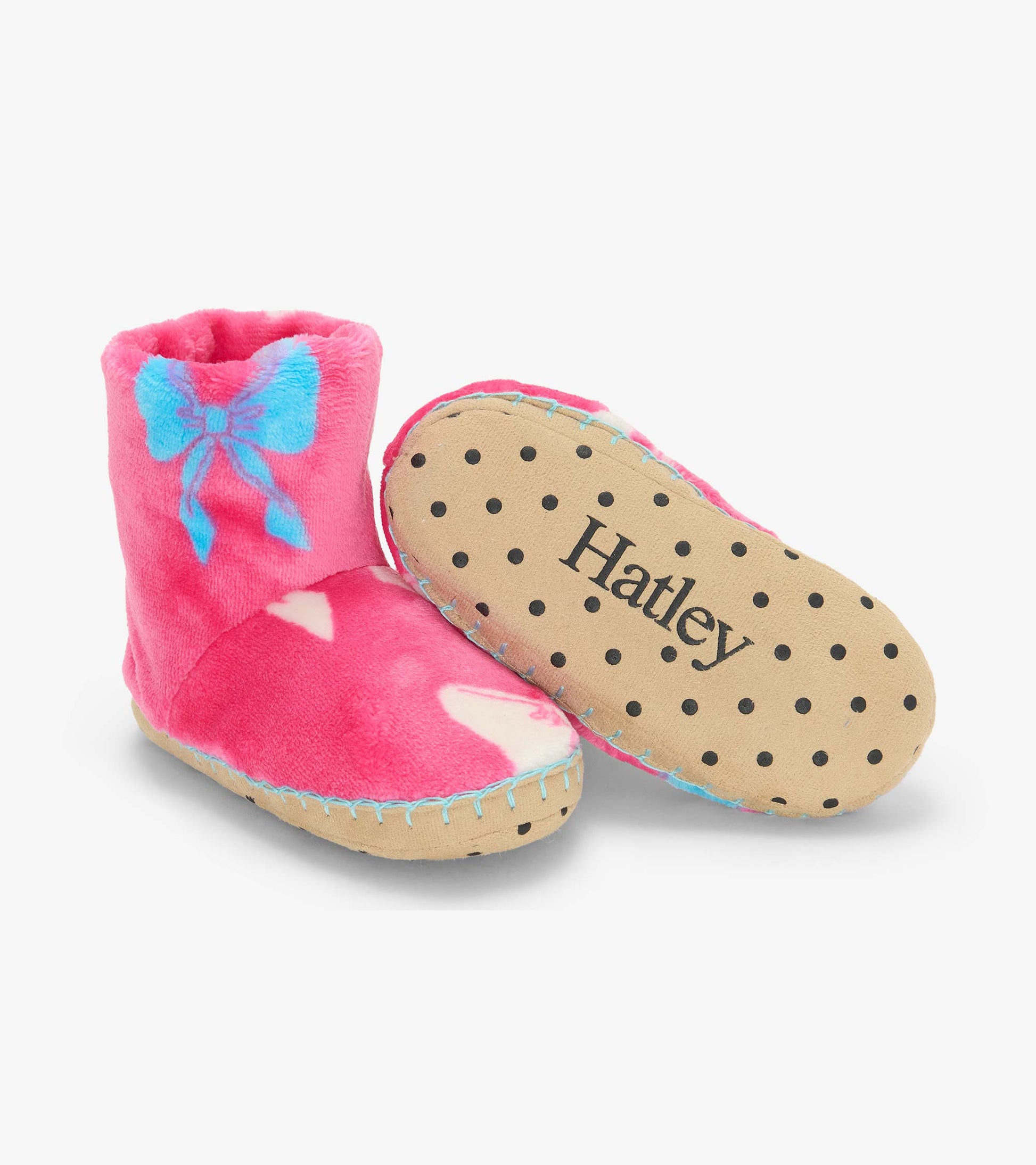 Pink slipper boots with blue bow print, showing one boot and the dotted sole with Hatley logo
