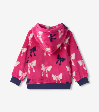 Back view of bright pink hooded fleece with white and navy bow print and navy ribbed cuffs and hem