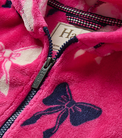 Close-up of pink bow-print hoodie showing zipper, hood lining, and Hatley neck label