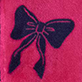 Dark textured bow on a bright pink background