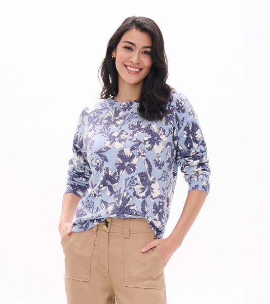 Model wearing light blue Noa sweater with oversized navy and white floral print