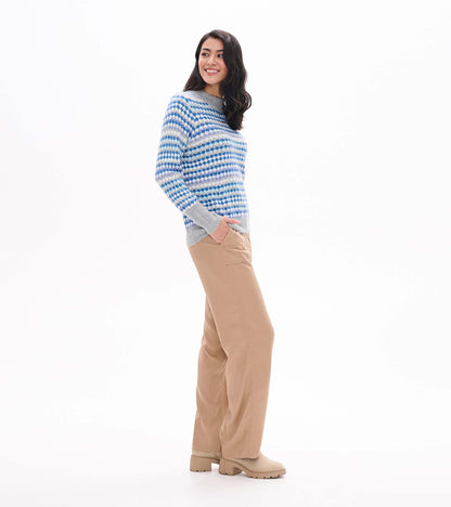 Side view of blue ombre sweater with dotted stripe pattern and gray mock neck and cuffs