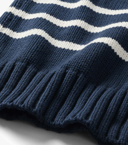 Close-up of the navy sweater with cream stripes and wide ribbed hem detail