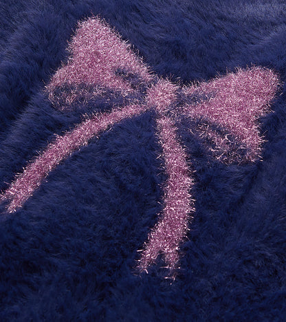 Close-up of pink bow detail on deep blue fuzzy cardigan
