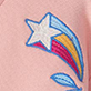 White star with blue outline and rainbow stripes on pink fabric