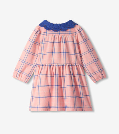 Back view of girls pink plaid long-sleeve dress with blue crochet collar and gathered skirt