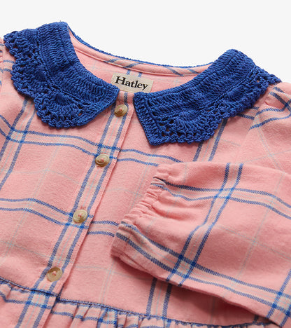 Close-up of pink plaid dress with blue crochet Peter Pan collar, front buttons, and elastic cuff