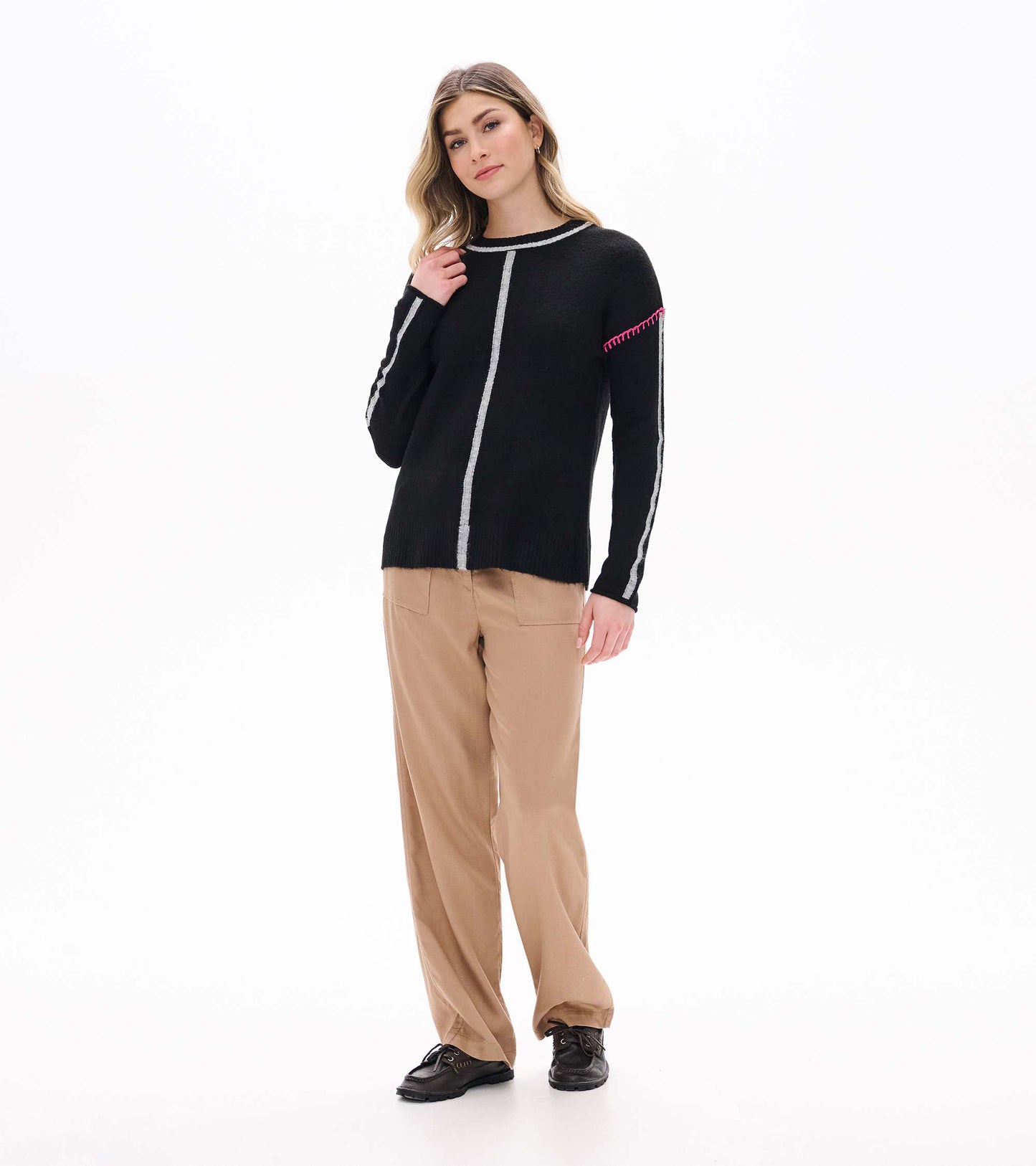 Full front view of black Maeve sweater with grey vertical stripe details and pink shoulder stitching