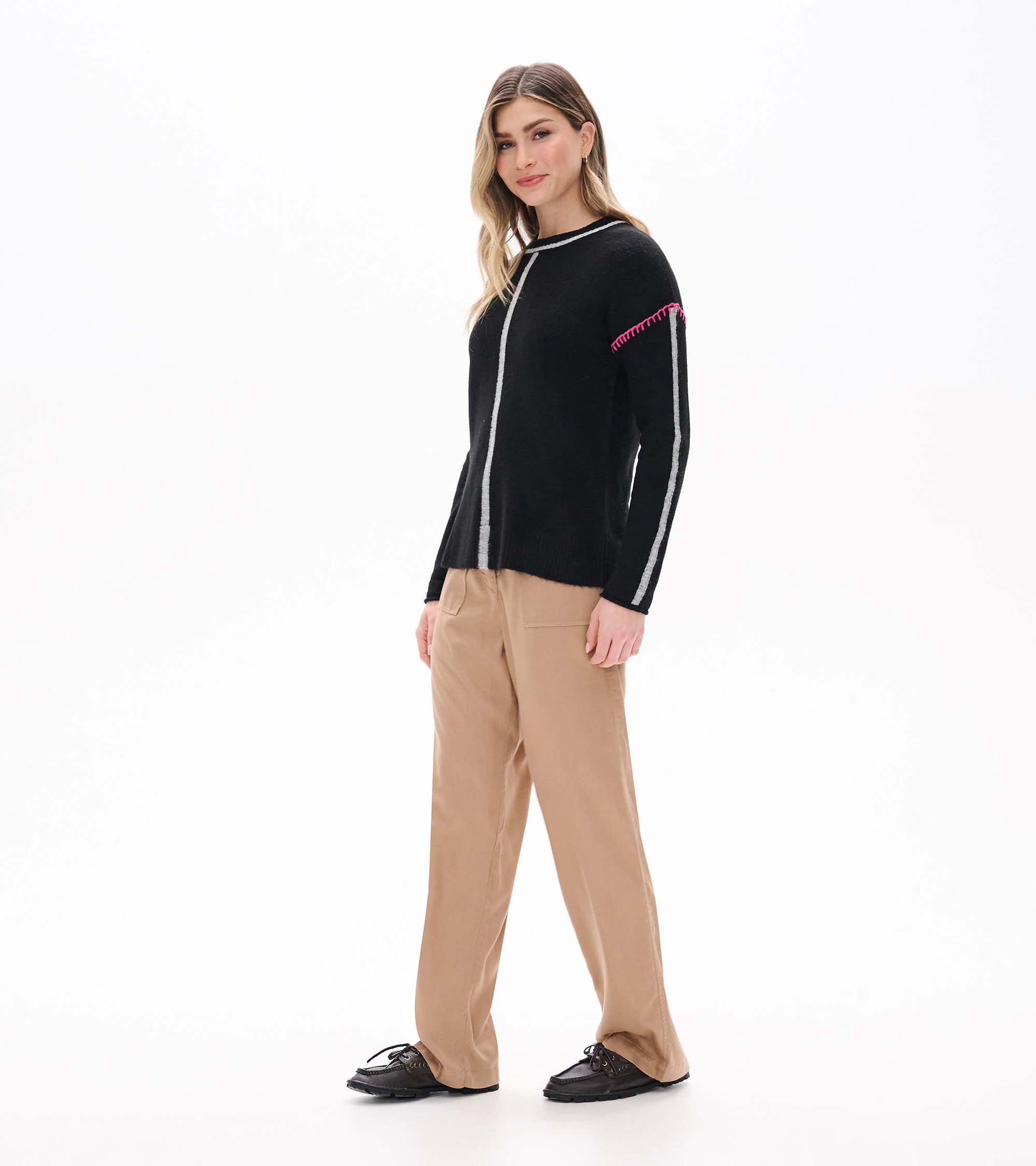 Side front view of black sweater with grey center and sleeve stripes and pink shoulder stitching