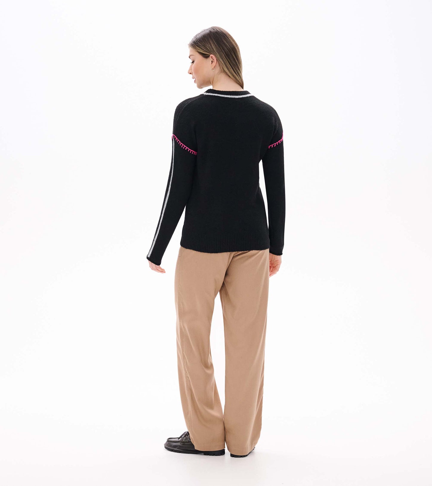 Back view of Maeve sweater in black with grey neck trim, grey sleeve stripes, and pink stitching at the upper arms