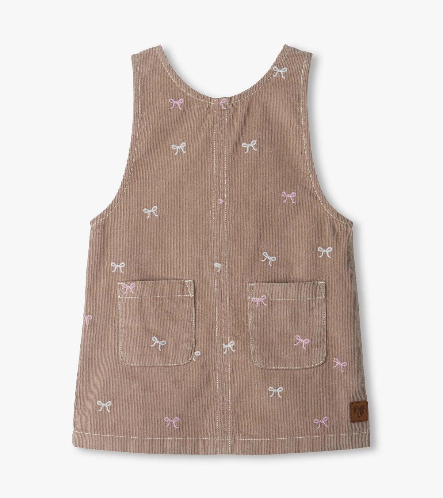 Front view of pink cord pinafore dress with embroidered bows and two front patch pockets