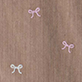 Brown wood grain surface with three small white bow motifs