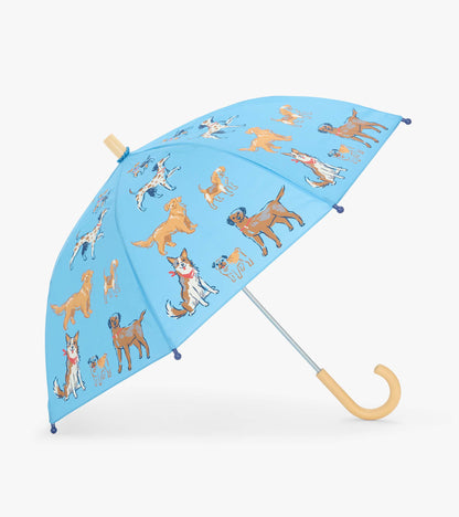 Open blue kids umbrella with illustrated dogs and a curved beige handle