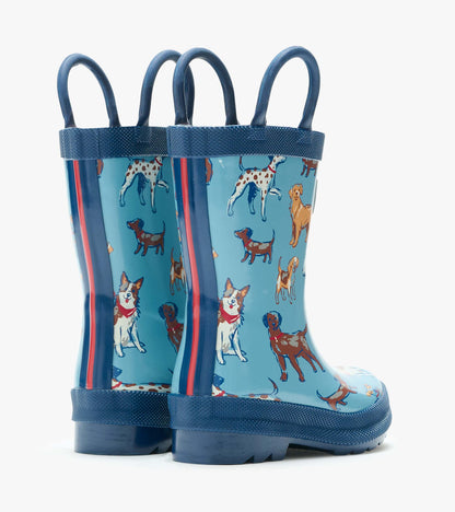 Back view of blue kids rain boots with navy handles and multicolor dog print