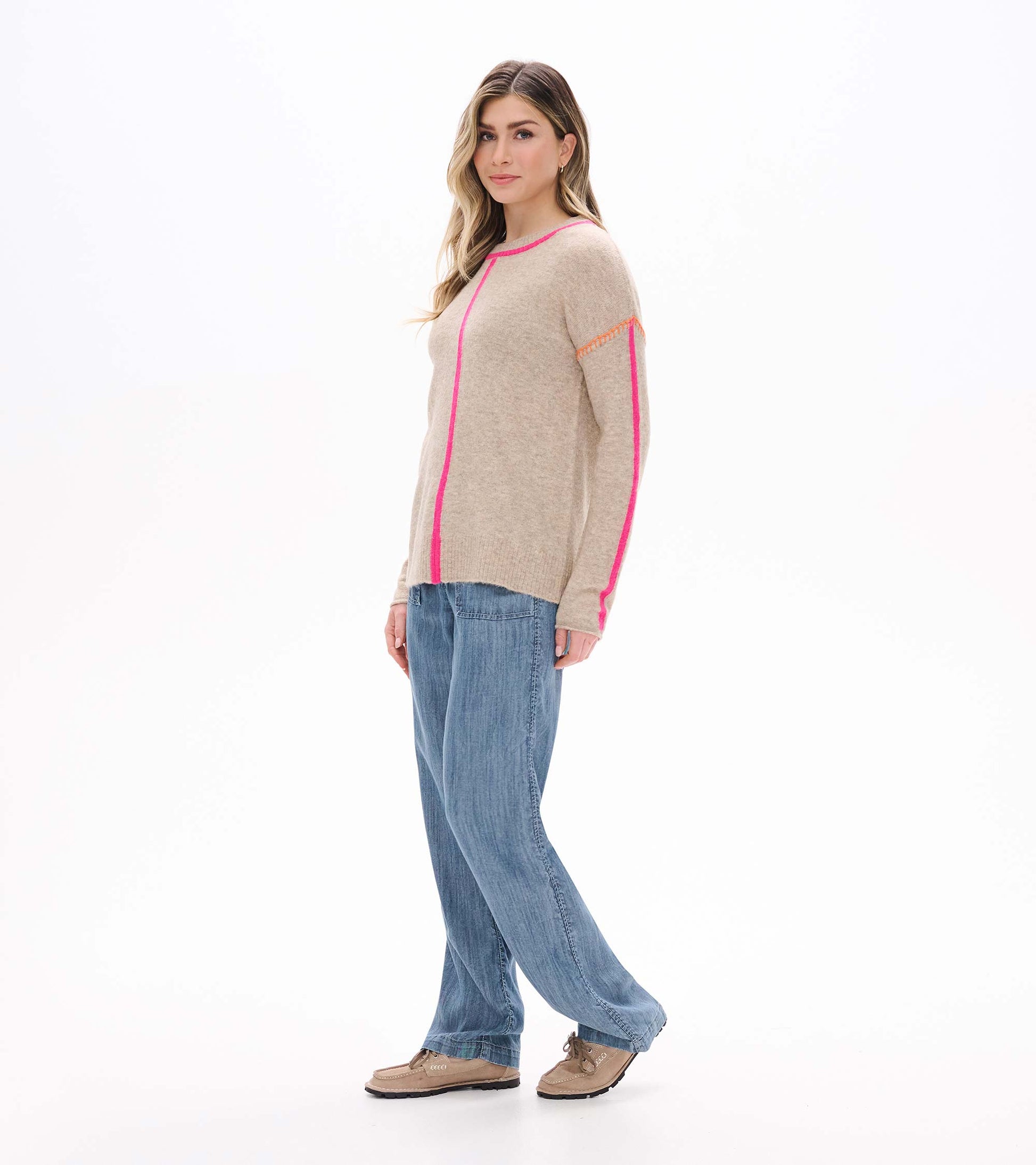 Side view of oatmeal sweater with neon pink trim and sleeve stripe