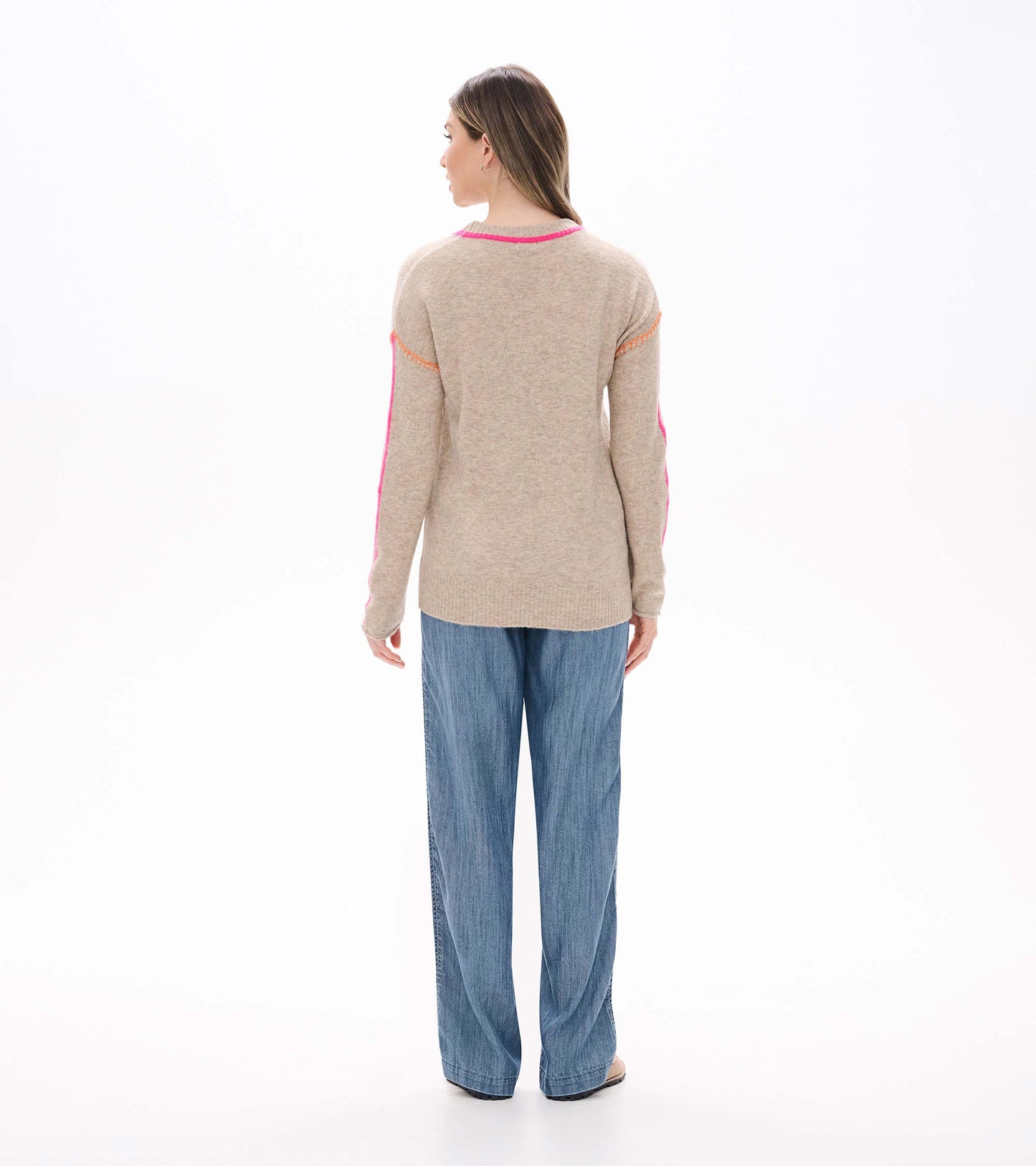 Back view of oatmeal sweater with neon pink neckline trim and sleeve stripes