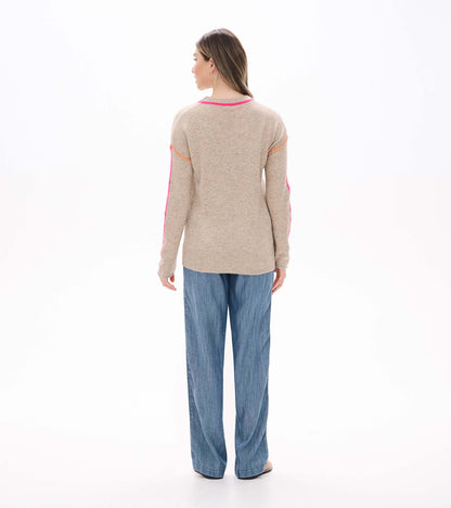 Back view of oatmeal sweater with neon pink neckline trim and sleeve stripes