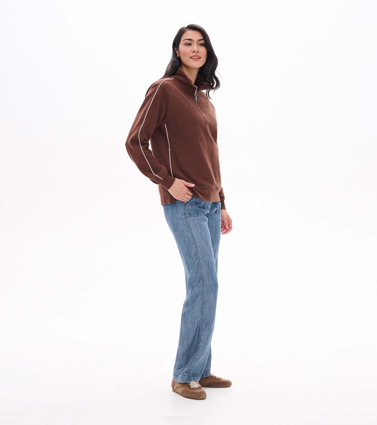 Side view of brown 1/4 zip top with stand collar, ribbed texture, and white sleeve piping