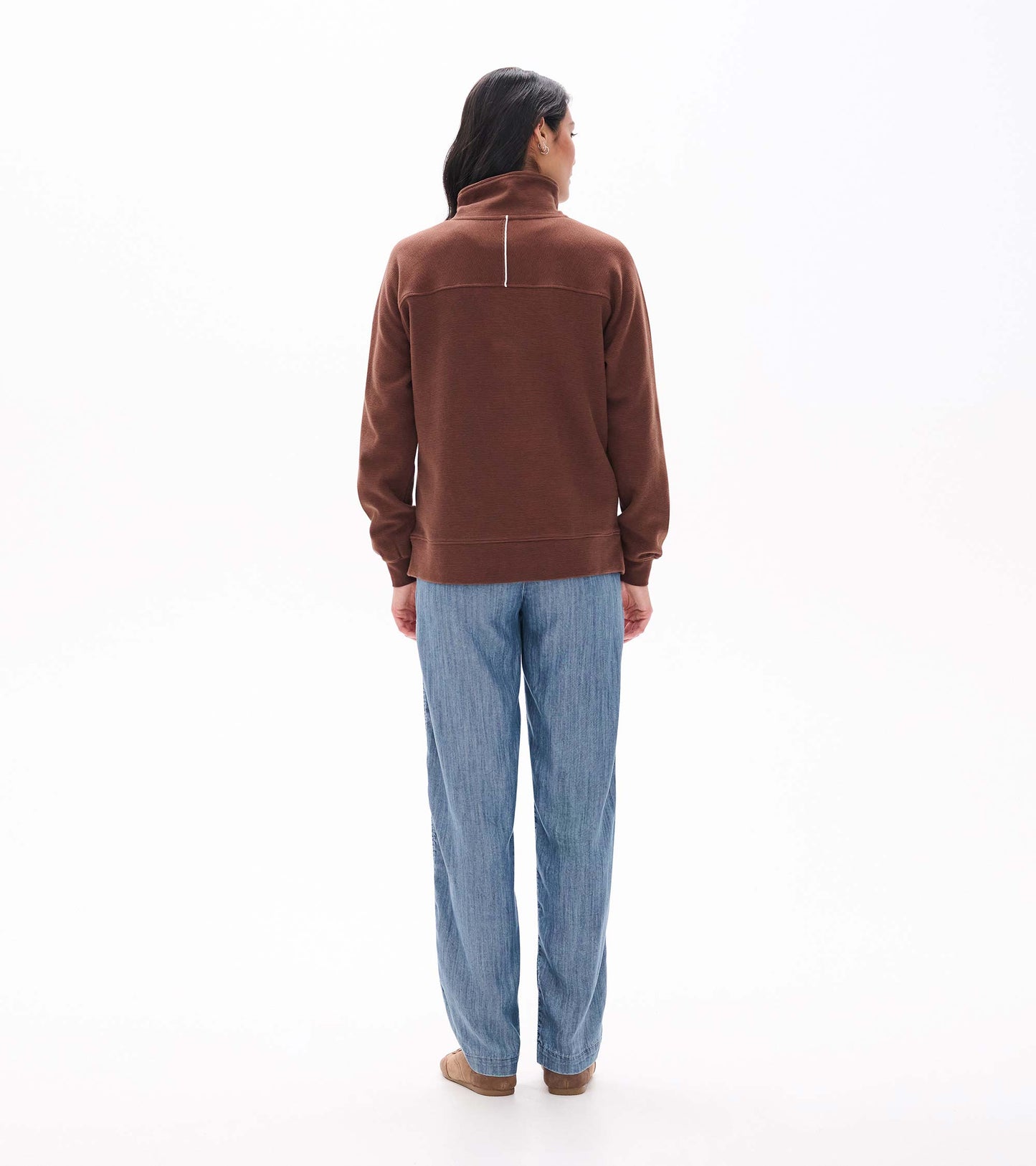 Back view of brown 1/4 zip top with stand collar and a white vertical stripe below the neck