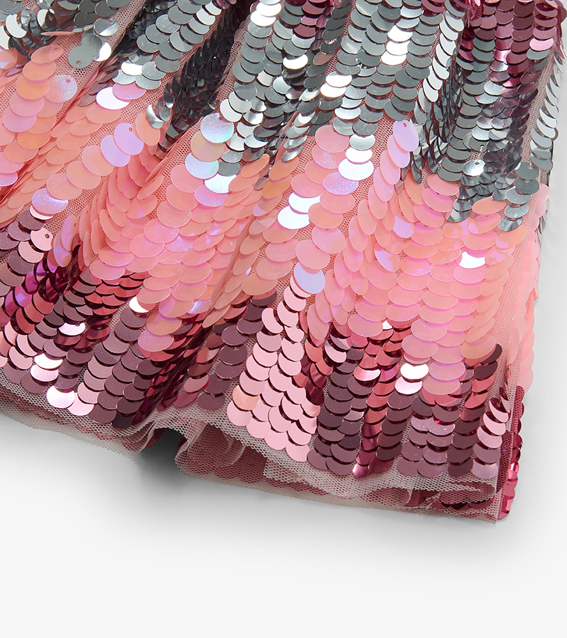 Close-up of pink, rose and silver gradient sequins on the skirt hem