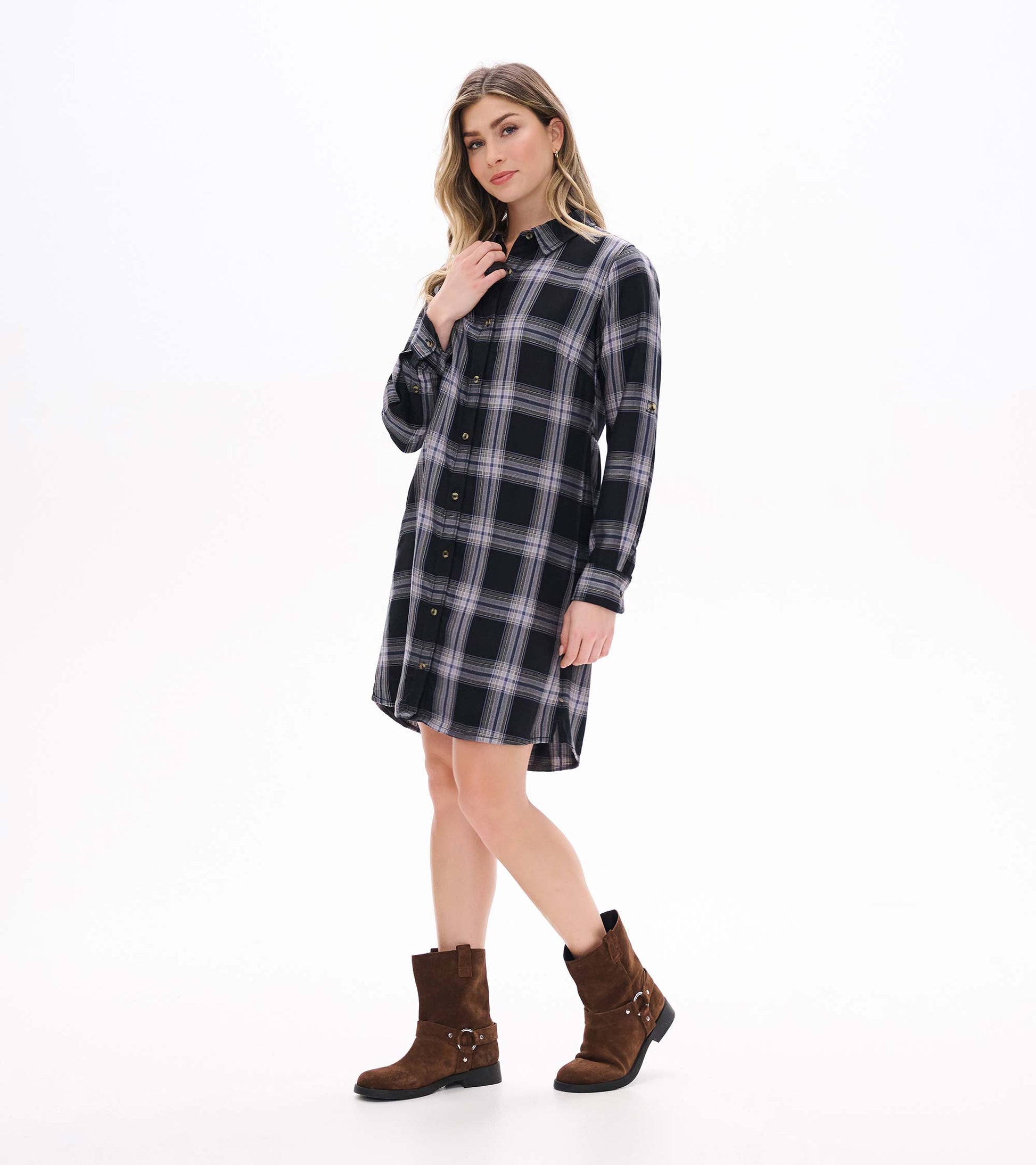 Angled front view of black and tan plaid shirt dress with collar, button front, and curved hem